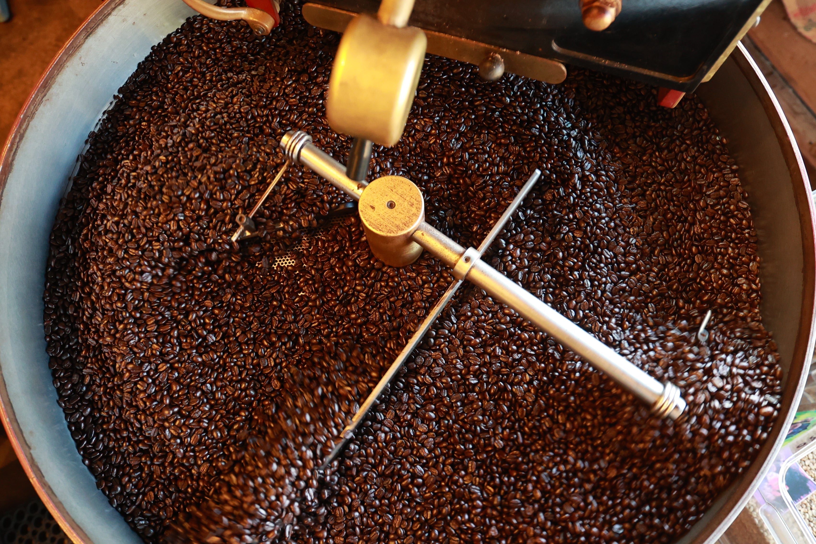 the coffee roaster at the St. Boni Mocha Monkey roasting coffee