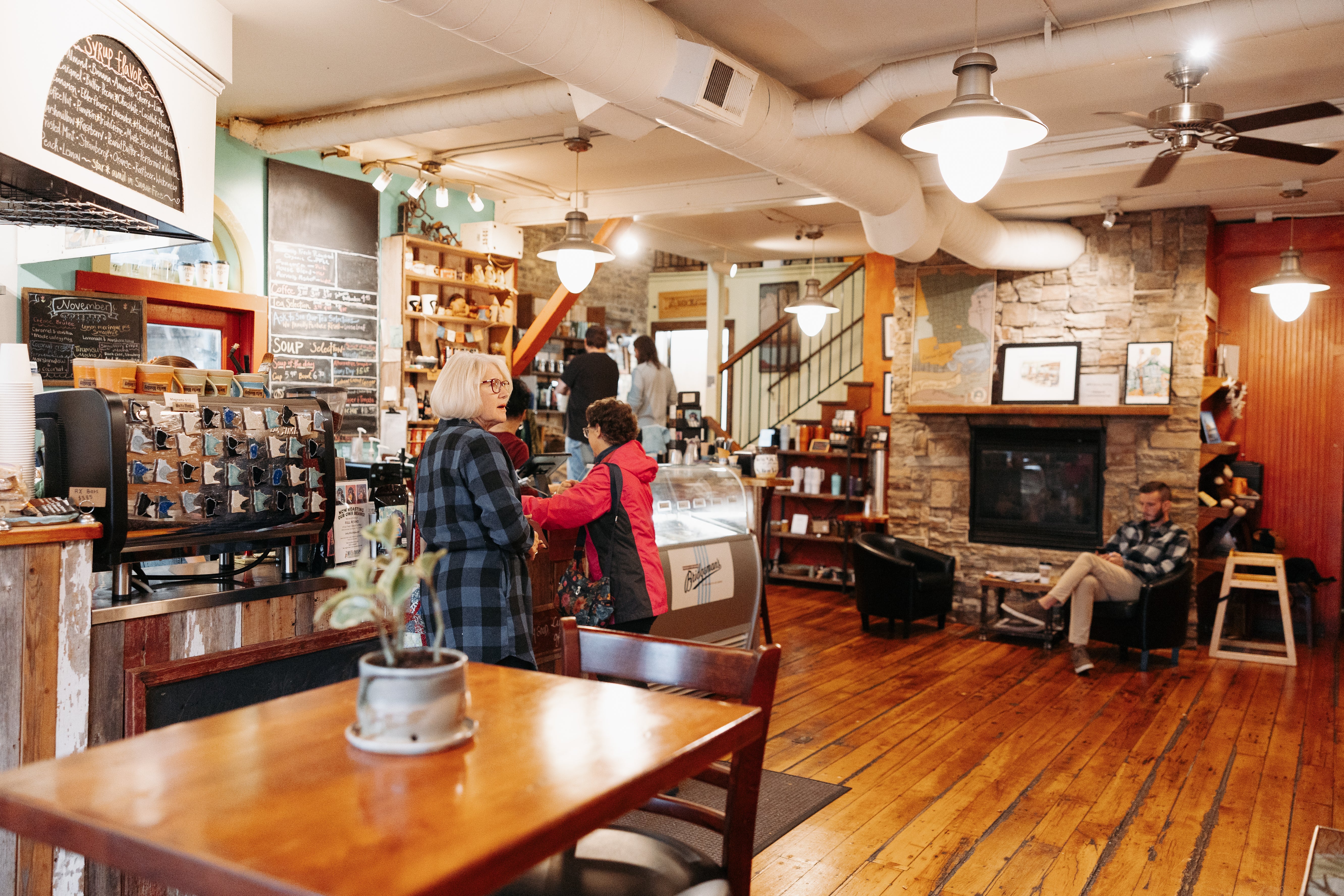 Inside the Mocha Monkey Coffeehouse in Downtown Waconia, a table in the foreground, two women at the counter, a man seated and two men talking in the background