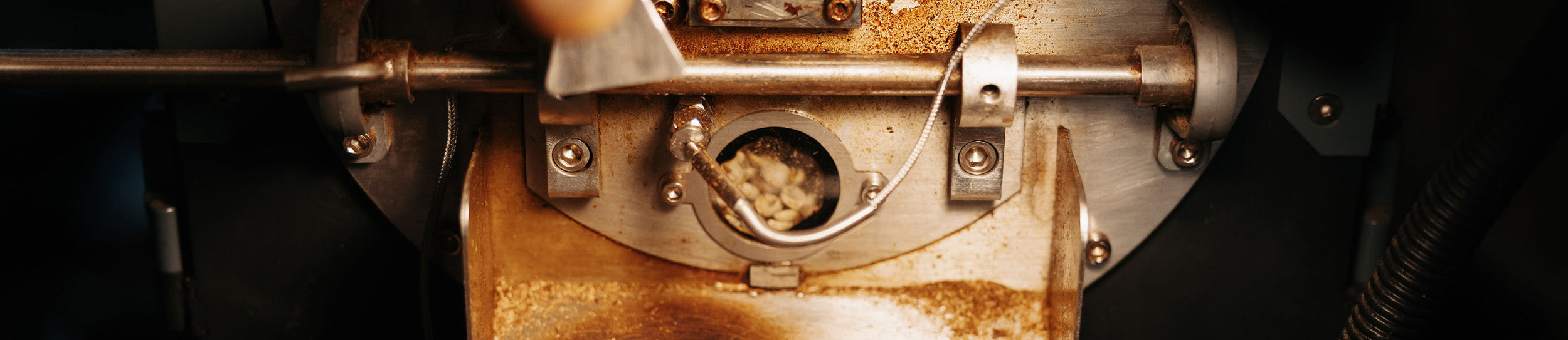 A closeup of coffee in a roaster—roasting