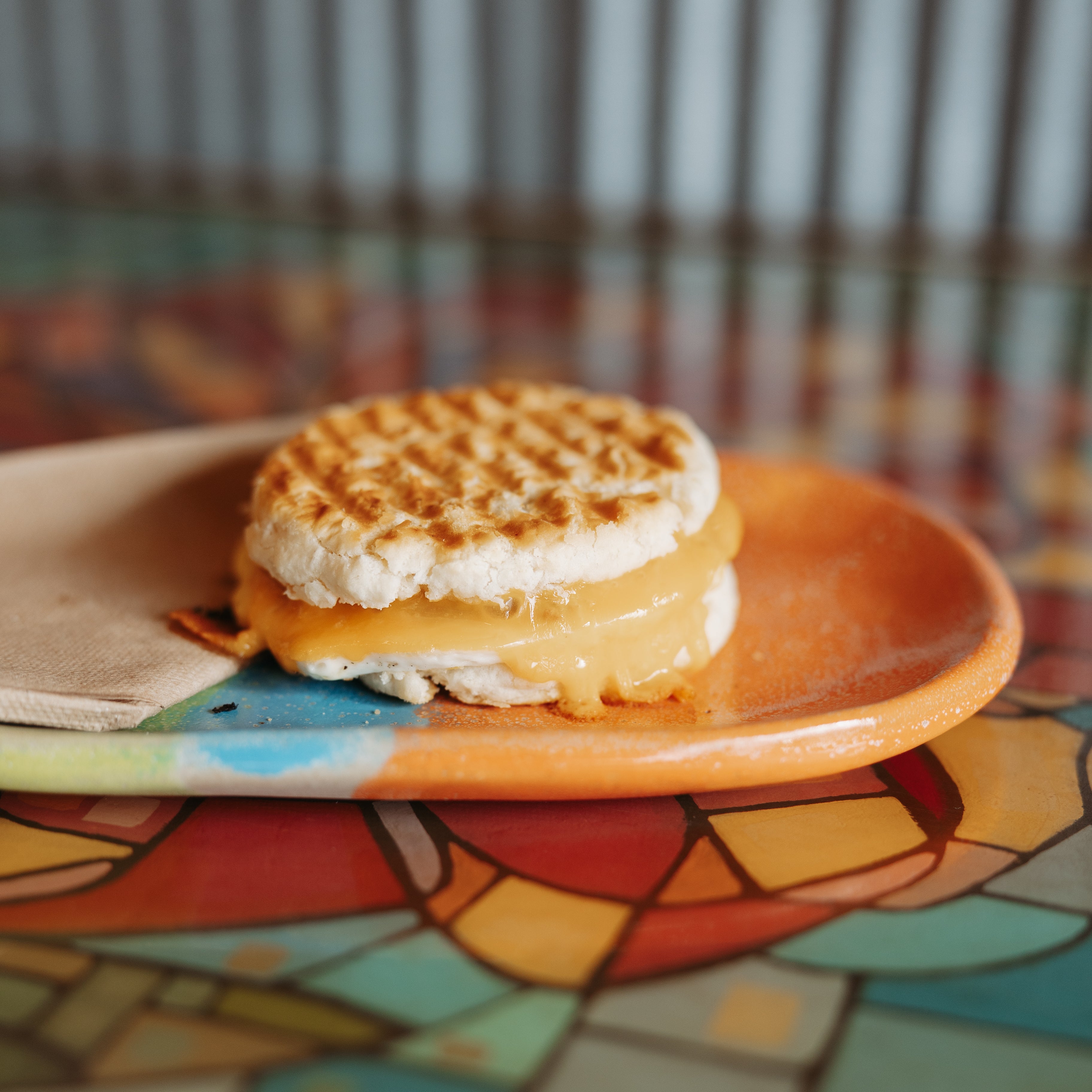 Grilled cheese Sandwich on a handmade plate on a hand painted tabletop